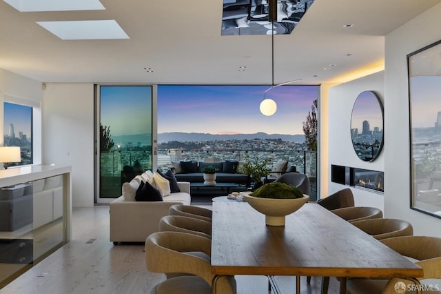 dining space with a mountain view and light hardwood / wood-style floors