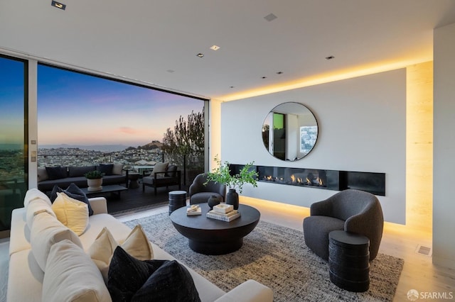 living room with light hardwood / wood-style floors and floor to ceiling windows