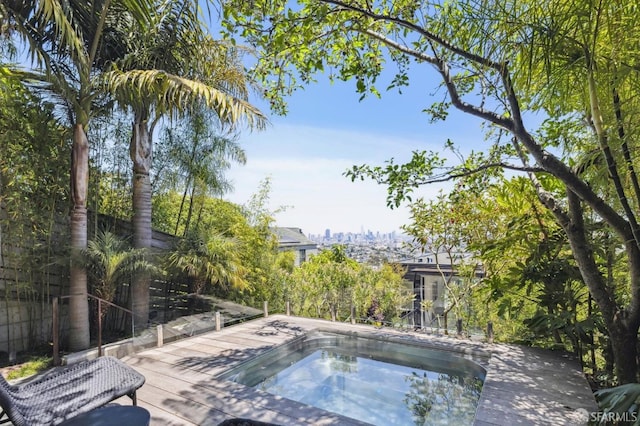 view of swimming pool with a deck and an outdoor hot tub