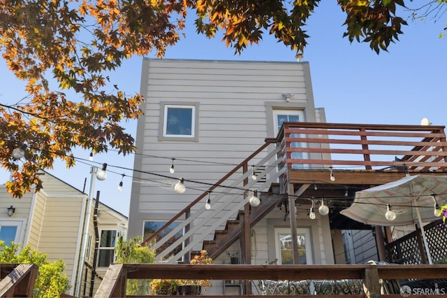 rear view of property featuring stairway