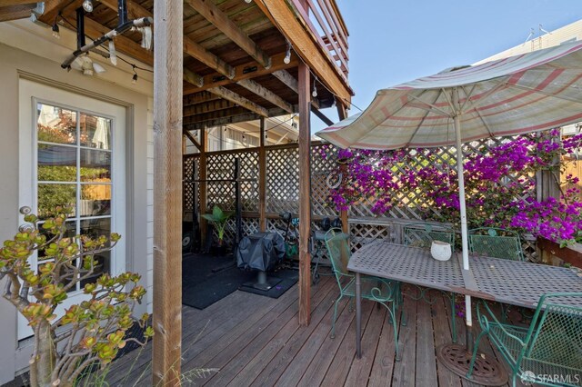 wooden terrace with a grill