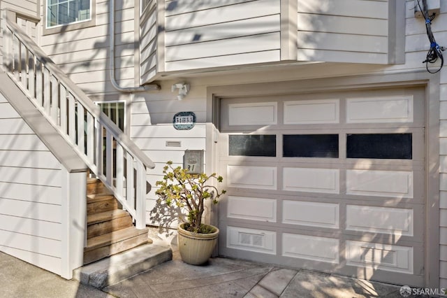 doorway to property with a garage