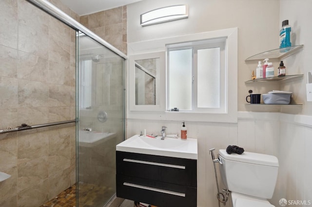 full bath featuring a stall shower, vanity, and toilet