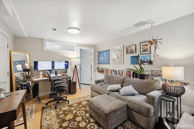 office space with light wood-style flooring and baseboards
