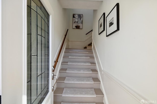 staircase featuring baseboards