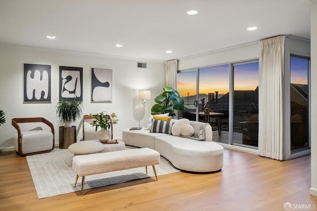 living room featuring wood finished floors, recessed lighting, and baseboards