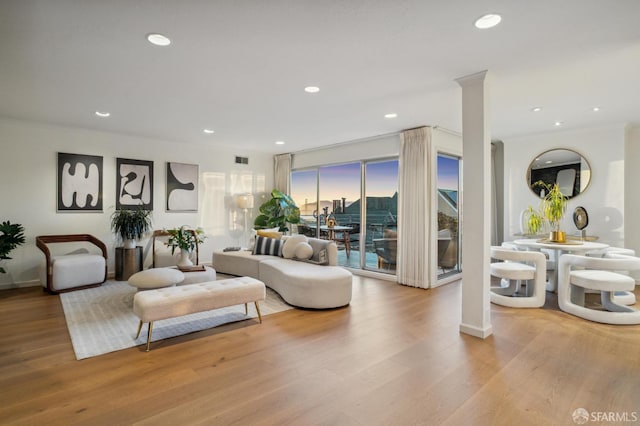 living area with recessed lighting, wood finished floors, and baseboards