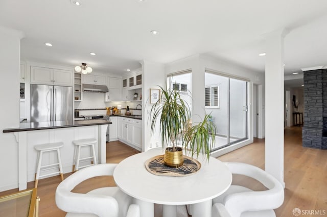 dining area featuring wood finished floors and recessed lighting