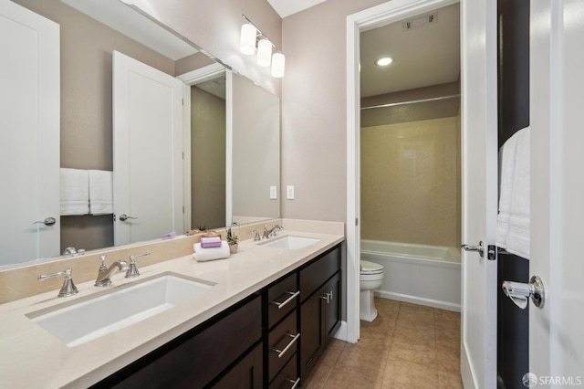 full bathroom featuring tile patterned floors, bathing tub / shower combination, vanity, and toilet