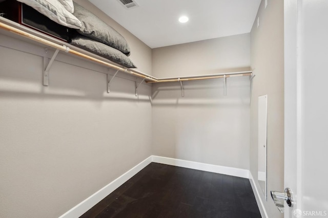 spacious closet with dark hardwood / wood-style floors