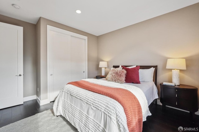 bedroom with a closet and dark hardwood / wood-style flooring