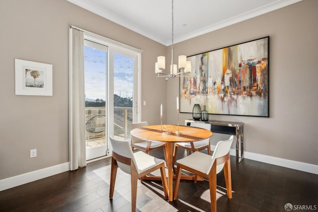 dining space featuring dark hardwood / wood-style flooring, crown molding, and an inviting chandelier