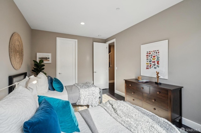 bedroom with dark hardwood / wood-style flooring