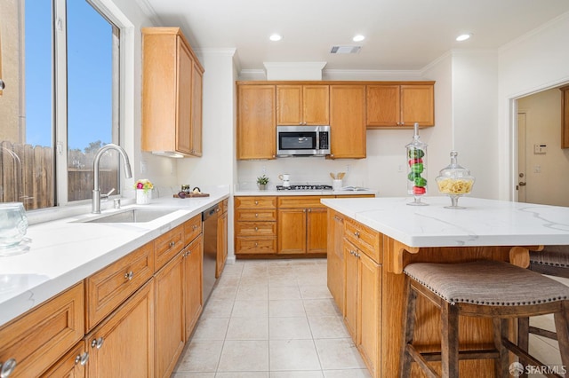 1845 Kern Mountain Way, Antioch, CA 94531 - kitchen with a sink, appliances with stainless steel finishes, ornamental molding, a breakfast bar, and light stone countertops