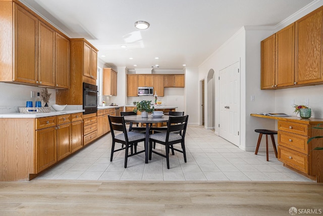 1845 Kern Mountain Way, Antioch, CA 94531 - kitchen featuring stainless steel microwave, oven, crown molding, arched walkways, and brown cabinetry