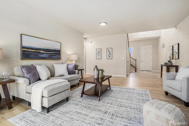 1845 Kern Mountain Way, Antioch, CA 94531 - living room with light wood finished floors, baseboards, stairs, and arched walkways