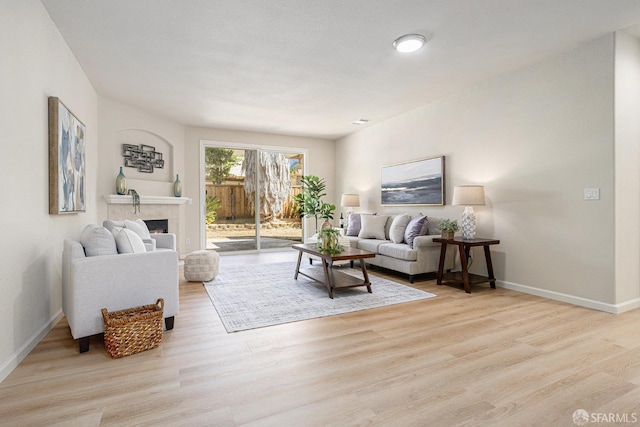 1845 Kern Mountain Way, Antioch, CA 94531 - living room with baseboards, light wood-style flooring, and a tile fireplace