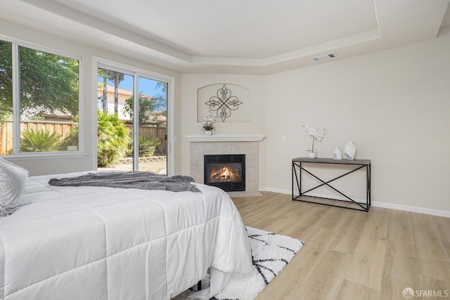 1845 Kern Mountain Way, Antioch, CA 94531 - bedroom featuring a raised ceiling, wood finished floors, a fireplace, and baseboards