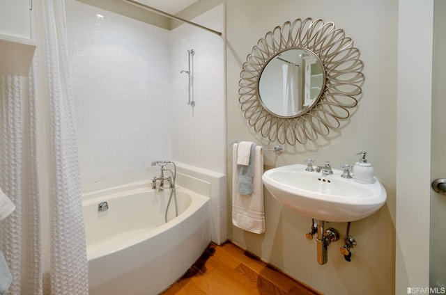 bathroom with shower / bath combo with shower curtain and hardwood / wood-style flooring