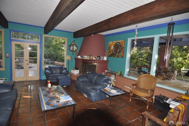 living area featuring a large fireplace, french doors, beamed ceiling, and tile patterned flooring