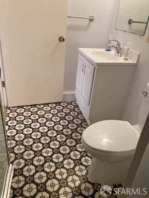 bathroom featuring toilet and vanity