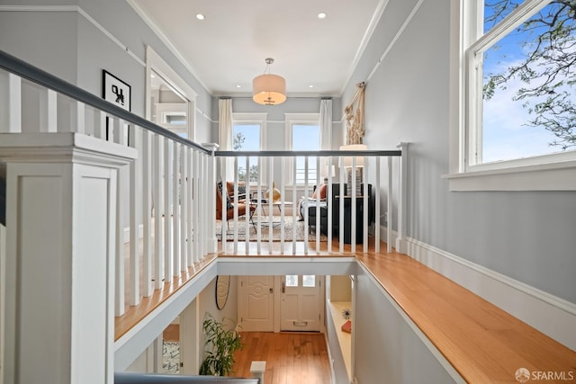 staircase with crown molding, recessed lighting, and wood finished floors