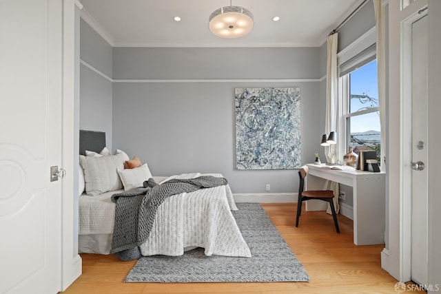 bedroom featuring ornamental molding, recessed lighting, light wood-style flooring, and baseboards