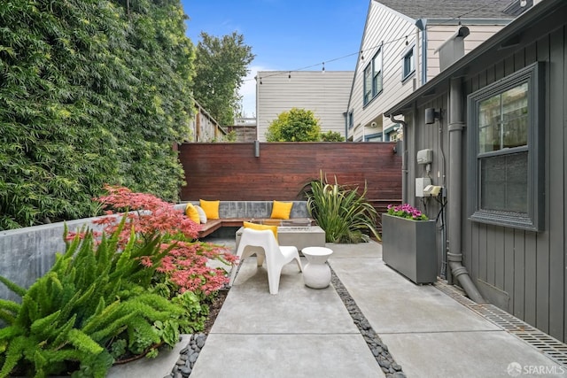view of patio with fence and an outdoor hangout area