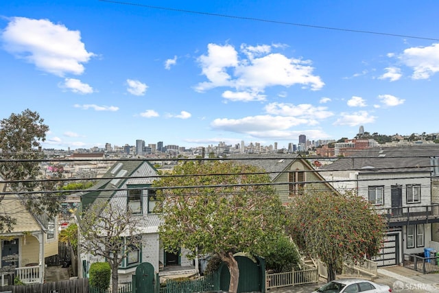 view of building exterior with a city view and fence private yard