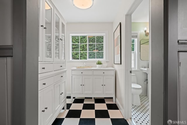 bathroom featuring tile patterned floors, vanity, and toilet