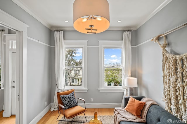 sitting room with light wood finished floors, baseboards, and plenty of natural light