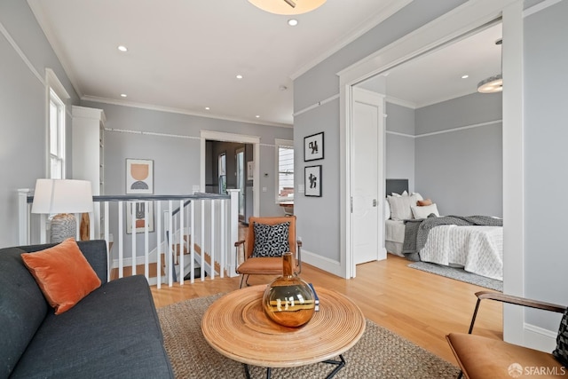living area with wood finished floors, recessed lighting, ornamental molding, and baseboards