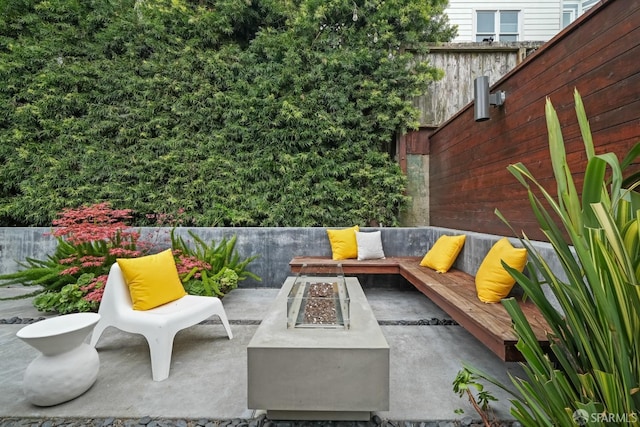 view of patio / terrace with fence and an outdoor fire pit