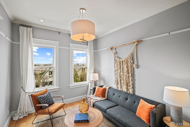 living area featuring crown molding, recessed lighting, wood finished floors, and baseboards