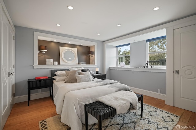 bedroom featuring recessed lighting, light wood finished floors, and baseboards