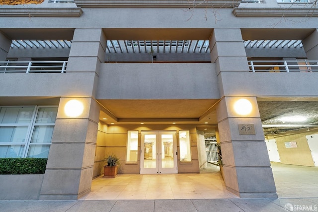 view of exterior entry featuring french doors