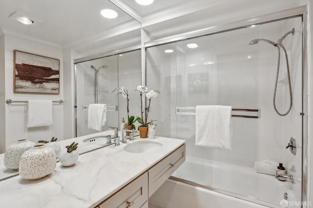 bathroom featuring crown molding, combined bath / shower with glass door, and vanity