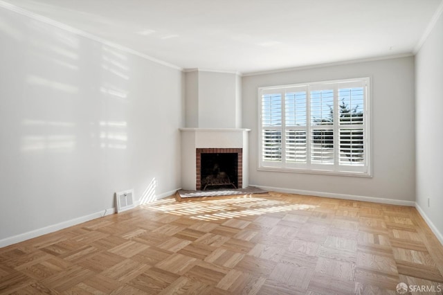 unfurnished living room featuring baseboards, a brick fireplace, visible vents, and crown molding