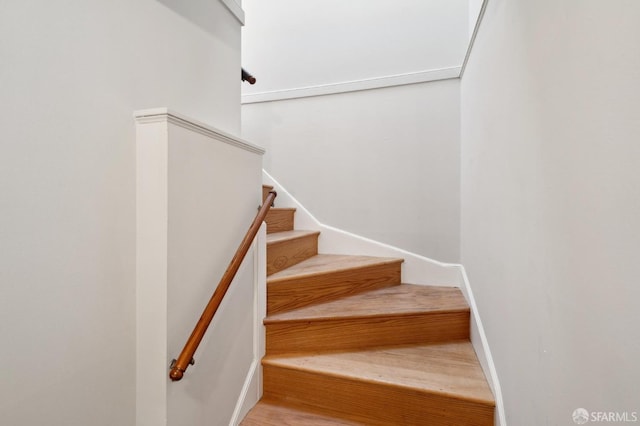 staircase featuring baseboards