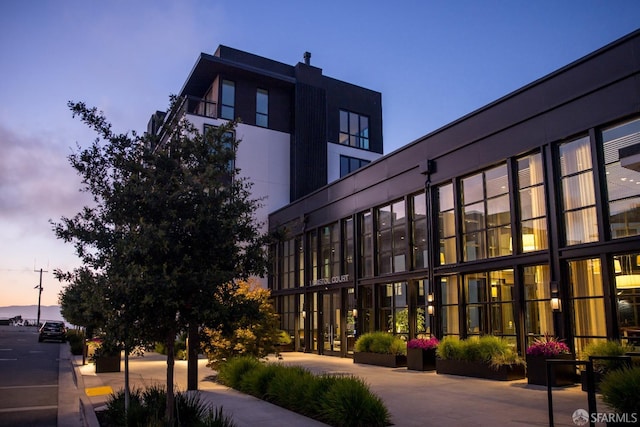 view of outdoor building at dusk