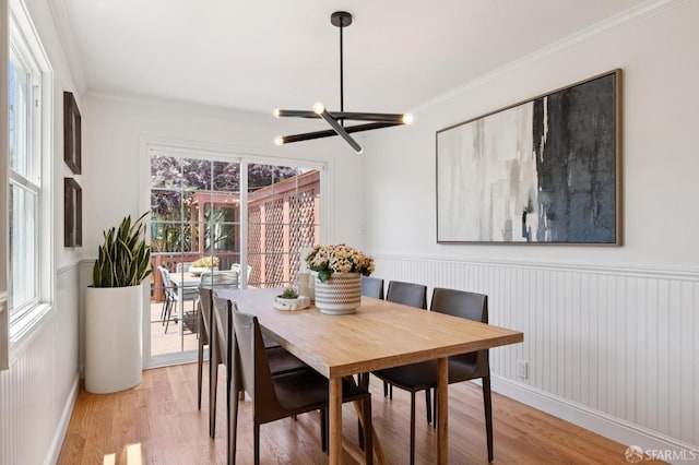 46 Otsego Ave, San Francisco, CA 94112 - dining area with a chandelier, light wood-type flooring, a wainscoted wall, and ornamental molding