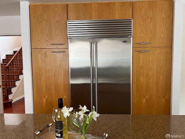 183 Lakeshore Dr, San Francisco, CA 94132 - kitchen featuring wood finished floors, dark stone counters, and stainless steel built in fridge