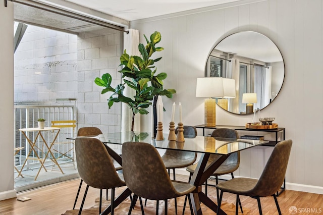 dining area with baseboards and wood finished floors