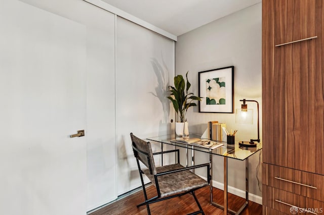 office area with baseboards and wood finished floors