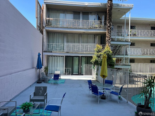 rear view of property with a patio area and fence