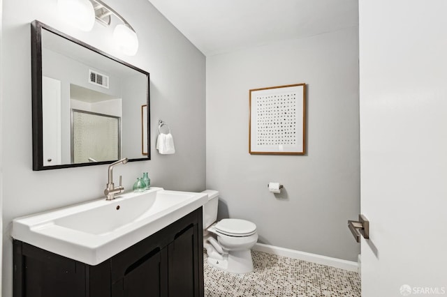 full bath with visible vents, baseboards, toilet, vanity, and a shower stall