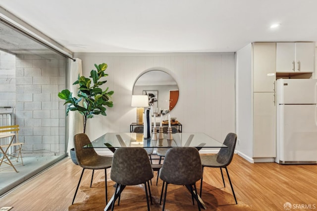 dining area with light wood-style flooring