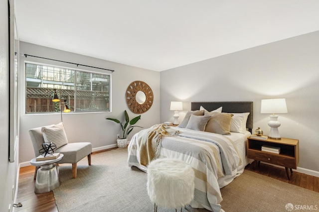 bedroom featuring baseboards and wood finished floors