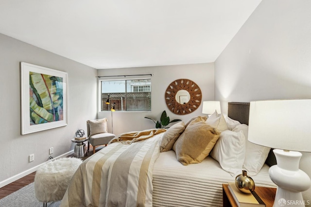 bedroom featuring baseboards and wood finished floors