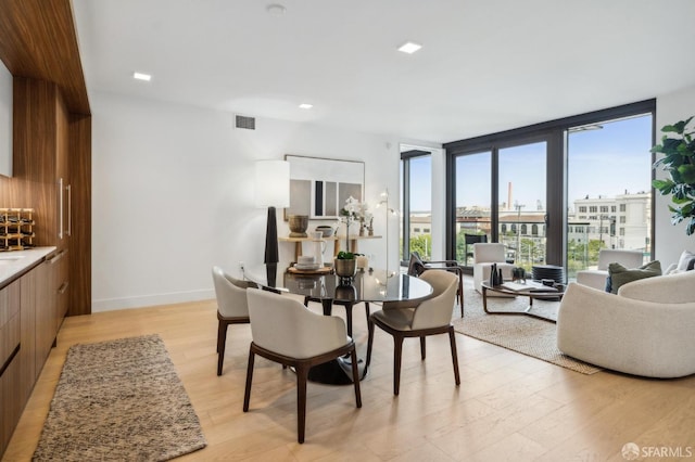 2177 3rd St Unit 421, San Francisco, CA 94107 - dining space featuring floor to ceiling windows, light wood-type flooring, and baseboards